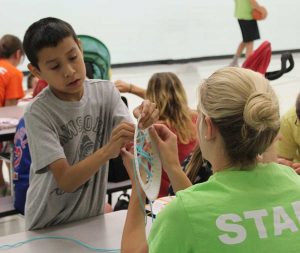 Staff Assisting Participant with Craft