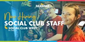 Now Hiring Social Club Staff for Social Club West in Lisle, IL. An Iamge of a young lady and young man smiles while playing an arcade console.